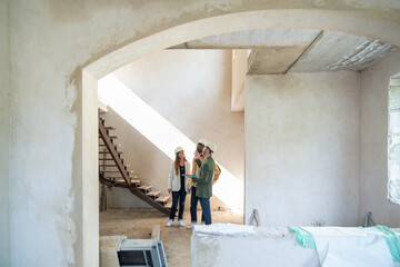 Architects Discussing Housing Project At Construction Site