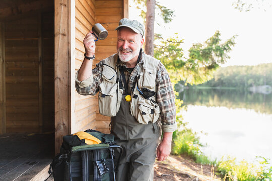 Fisherman Relaxing by Forest Cabin