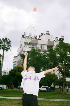 The boy is playing Badminton 