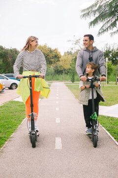A young family driving electric samovars down the road 