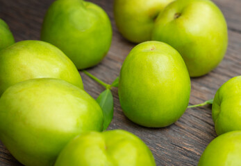 Green fresh jojoba on a wooden surface close
