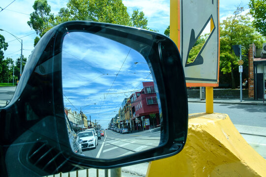 POV from car wing mirror of Melbourne street