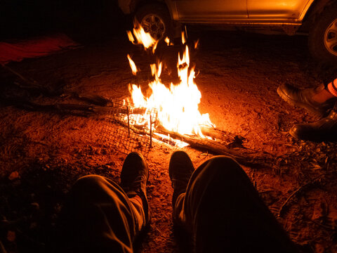 Sitting around a camp fire, while camping, outback Australia