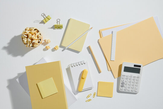 Office supplies on white desk background. Top view
