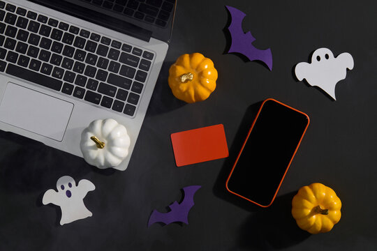 Halloween Decorations with Laptop, Phone and Pumpkins