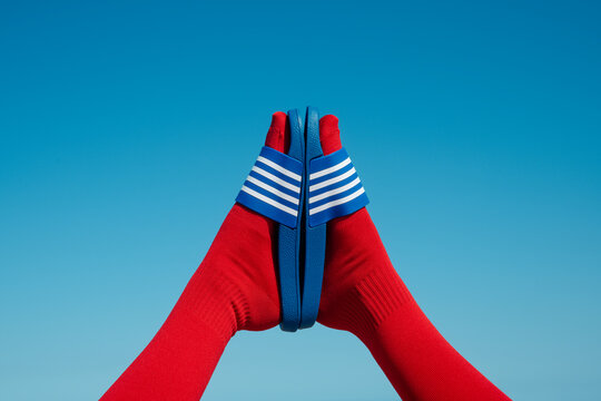 man wearing red socks and blue sandals