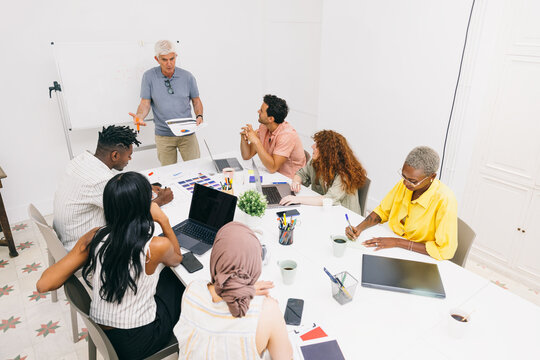 Business meeting with diverse team discussing project strategy
