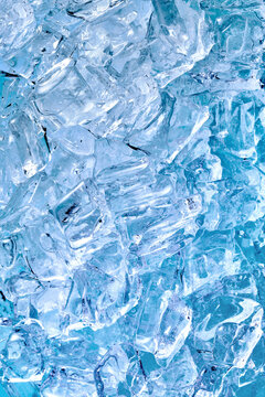 Background of frozen ice cubes of blue color