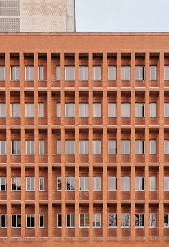 Symmetrical brick facade with grid pattern of windows on a building