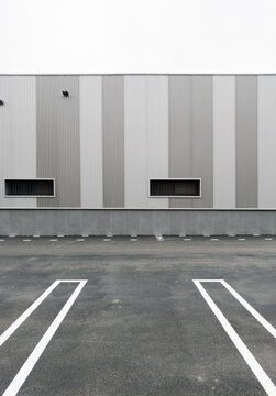 Modern industrial building with empty parking lot frontage