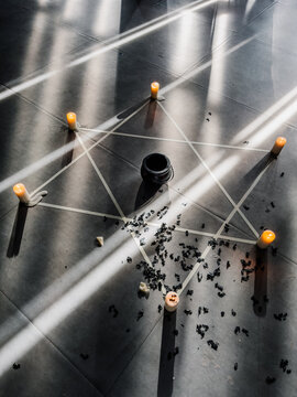 Ritual setup with pentagram of candles on the floor in sunlight