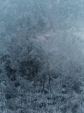 Abstract blue textured background resembling frosted glass surface