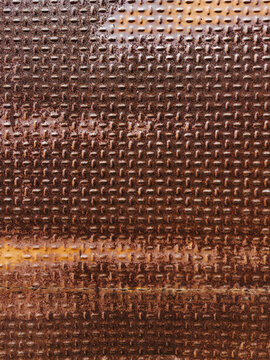 Detailed close-up of rusty textured metal surface with patterns