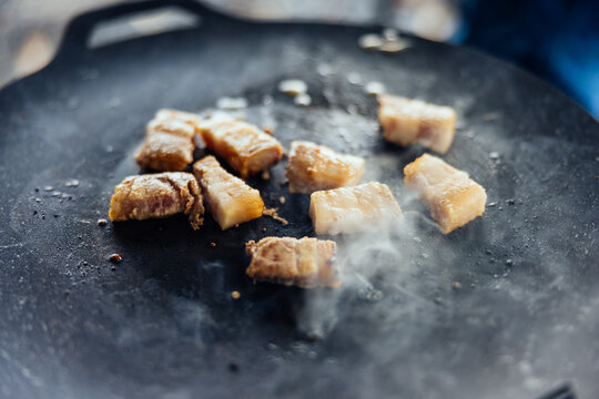 Grilling Pork Meat Cubes on a Hot Griddle