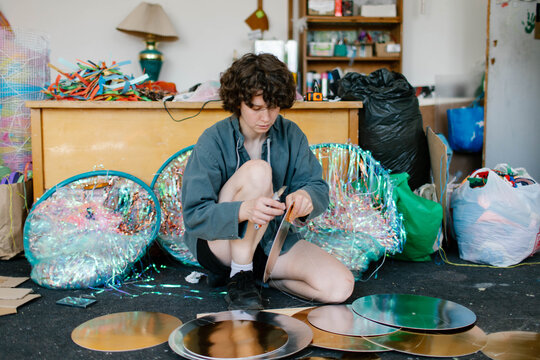a young woman makes decorations in the workshop