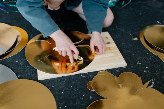 a young woman makes decorations in the workshop