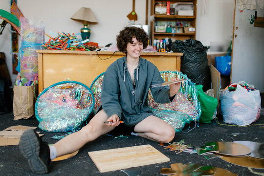 a young woman makes decorations in the workshop