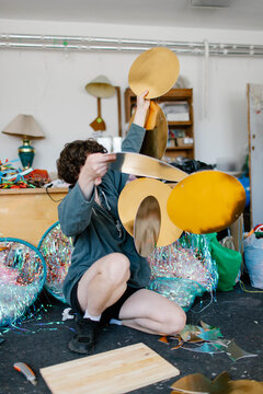 a young woman makes decorations in the workshop