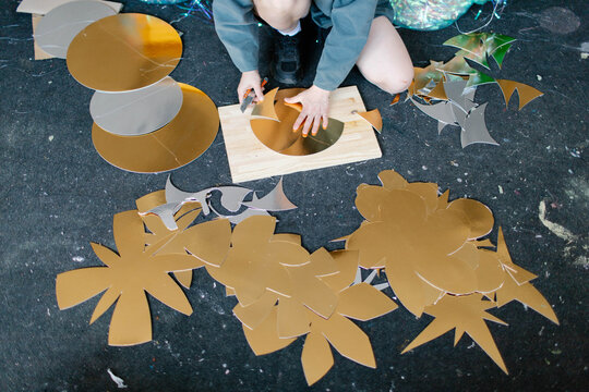 a young woman makes decorations in the workshop
