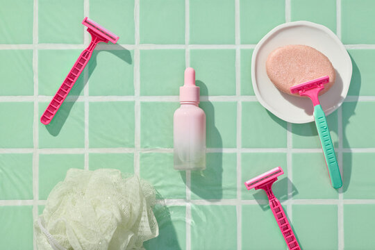Flat Lay Of Shaving Accessories On Mint Green Tile Background