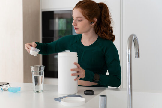 Woman Preparing Nutritional Supplements