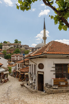Cobblestone Street with Traditional Houses and Minaret
