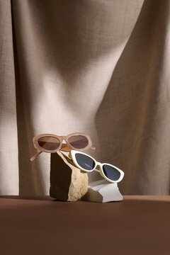 Designer Sunglasses Display Against Elegant Fabric Background