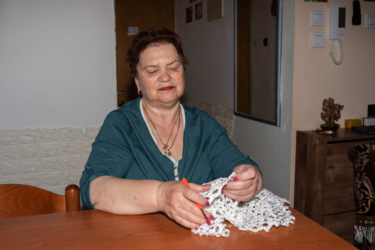 Senior Woman Crocheting At Home