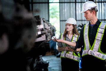 Factory engineers inspect on machine. Confident team mature businessman with laptop standing by robotic arm in industry businessman inspect at height technology for produce the electronic part device.