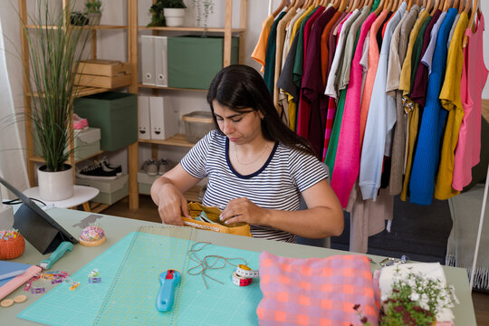 Fashion designer putting lining inside tote bag at home