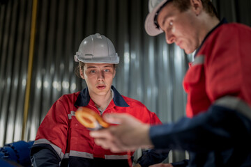 Obraz premium male engineer workers maintenance automatic robotic arm machine in a factory. worker checking and repairing automatic robot hand machine. technician worker check for repair factory machine.