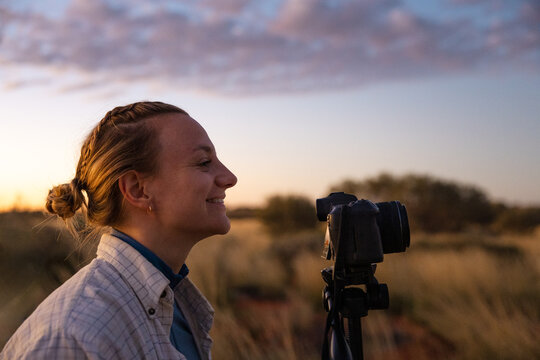 Photographer capturing a sunset time-lapse in Uluru