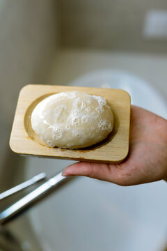 natural soap  in a wooden soap dish