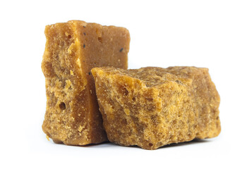 pieces of artisanal sugar cane panela on an isolated white background