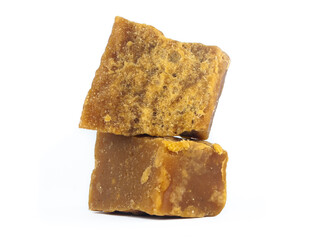 pieces of artisanal sugar cane panela on an isolated white background