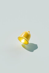 Illuminated Yellow Bell on Blue Background