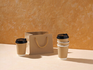  Three to-go cups with lids and a bag on a table