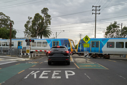 Car Waiting at Train Crossing in Melbourne