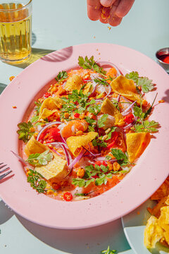 Person putting spices on a super fresh Prawn ceviche