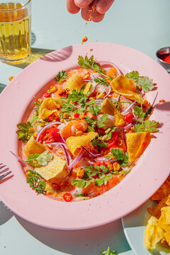 Person putting spices on a super fresh Prawn ceviche