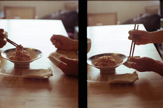 Two people's hands are making dumplings