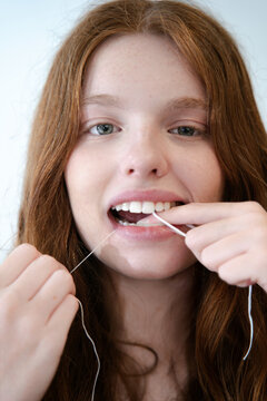 Woman Flossing Teeth