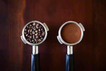 Ground coffee and roasted coffee beans in portafilter holder with background. Close up