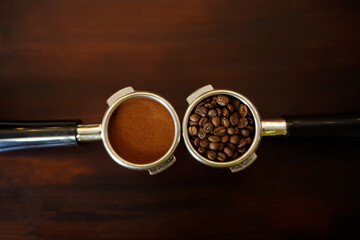 Ground coffee and roasted coffee beans in portafilter holder with background. Close up