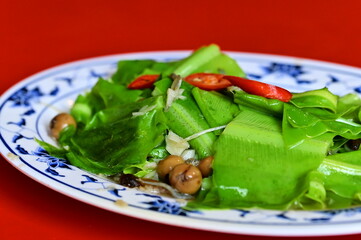 Enjoy a vibrant dish of stir-fried Bird's-nest Fern with Silver Fish, also known as bracken, paired with garlic, silver fish. A beloved Taiwanese treat with a unique taste.
