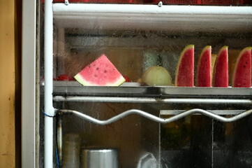 A vibrant shot of watermelon stored in the freezer, showcasing its juicy red flesh and cool refreshment, perfect for summer hydration and vitamin C boost.