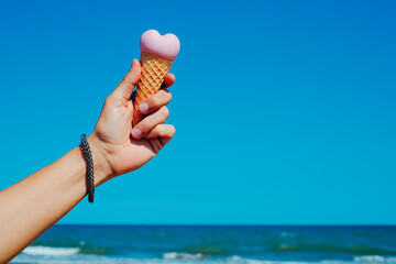 man with a heart-shaped ice cream cone on the beach 