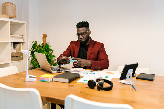 Man Reviewing Documents at Desk