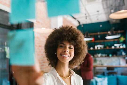 Smiling Woman Planning with Sticky Notes