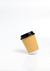 Levitating Isolated Brown Beige Paper Drinks Mug, Cup with Black Lid, Straw On White Background. Eco Hot Beverage Tumbler. On the Go Food Service Application. Vertical Plane, Copy Space.